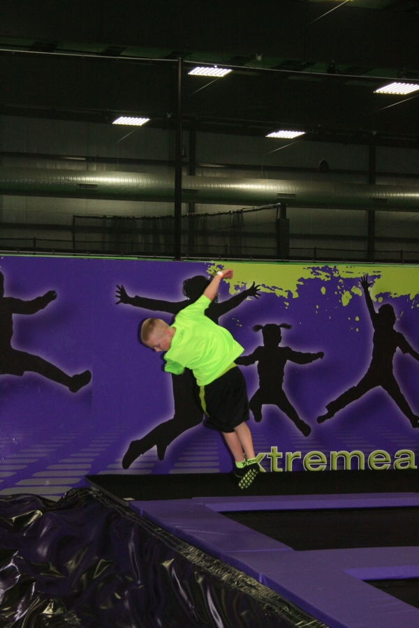 Boy Doing Half Twist Off Trampoline into Stunt Airbag